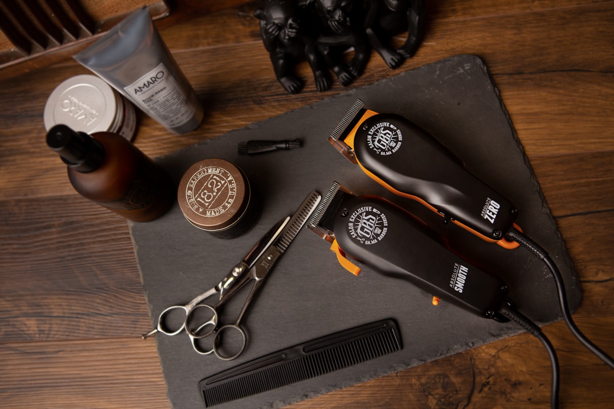 Barbering tools laid out: clippers, shears, and comb